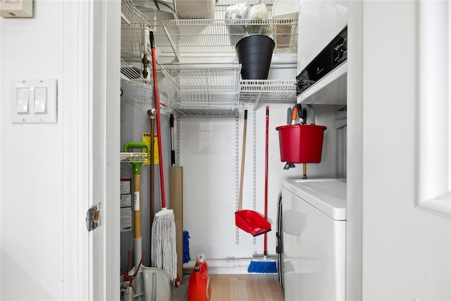 washroom featuring hardwood / wood-style flooring and washer / dryer