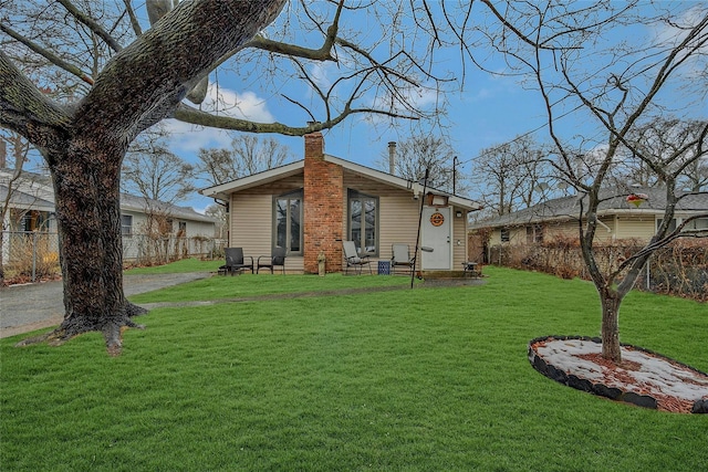 rear view of house with a yard