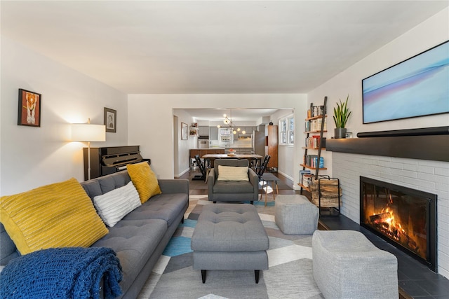 living area featuring a fireplace and baseboards