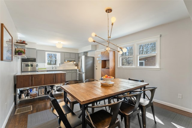 dining room with visible vents, baseboards, and dark wood-style flooring