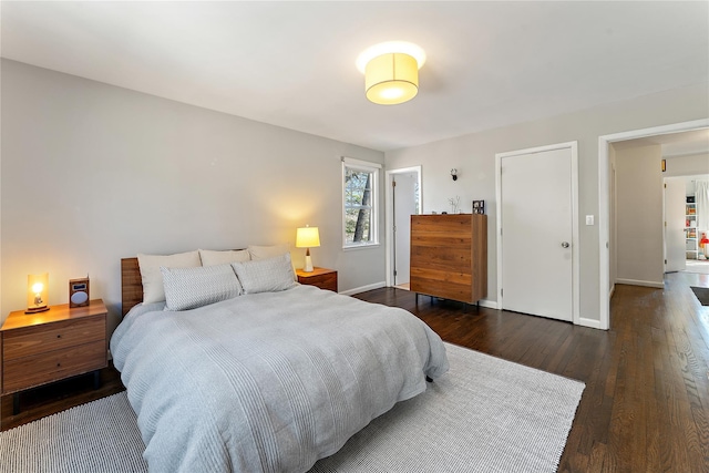 bedroom featuring dark wood-style floors and baseboards