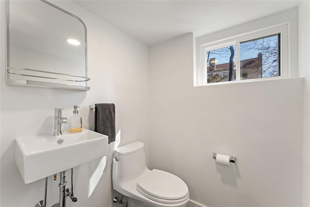 bathroom with toilet and a sink