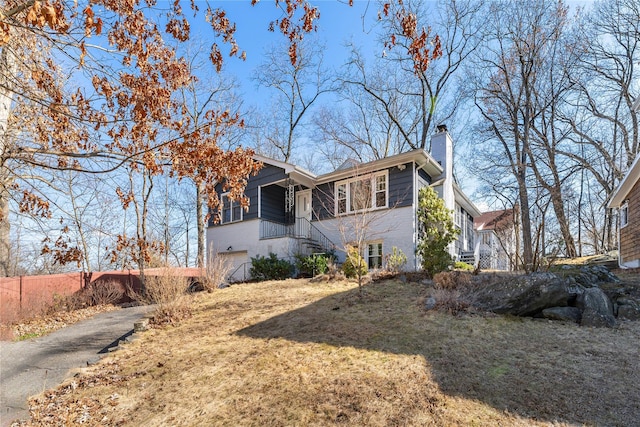 view of front of home with a chimney and a front lawn