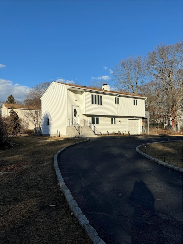 back of property with a garage