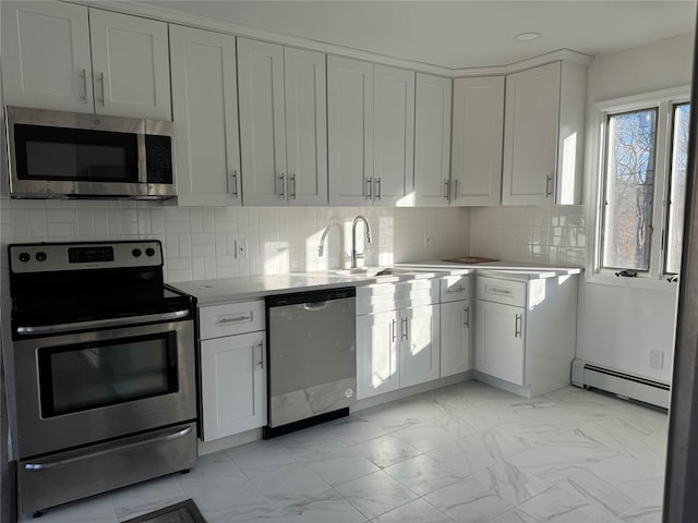 kitchen with white cabinetry, appliances with stainless steel finishes, and a baseboard heating unit