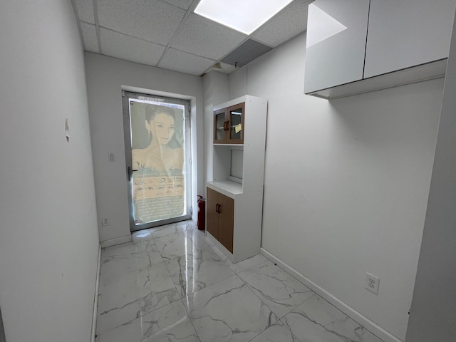 doorway to outside featuring a paneled ceiling