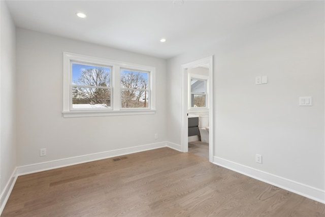 unfurnished room with light wood-type flooring