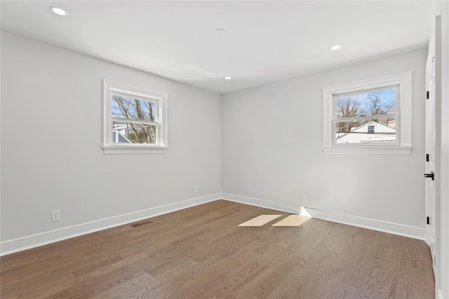 spare room featuring wood-type flooring