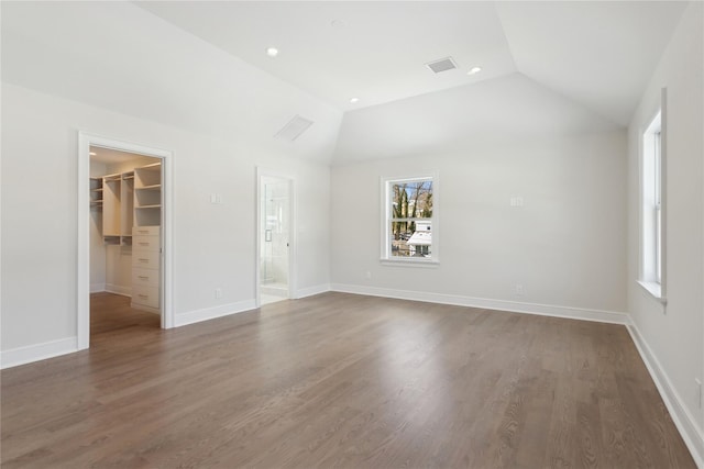 interior space featuring dark hardwood / wood-style flooring and lofted ceiling