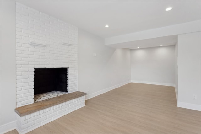 unfurnished living room with light hardwood / wood-style floors and a fireplace