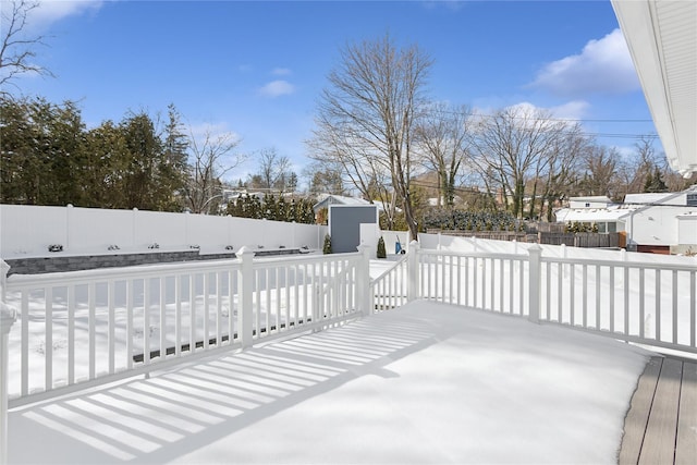 wooden terrace featuring a storage unit