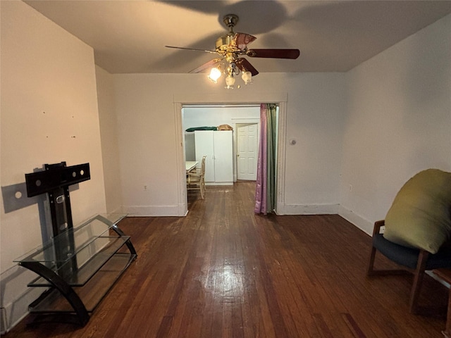 unfurnished living room with ceiling fan and dark hardwood / wood-style flooring