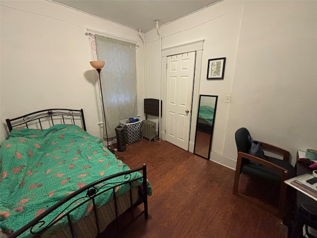 bedroom with dark wood-type flooring