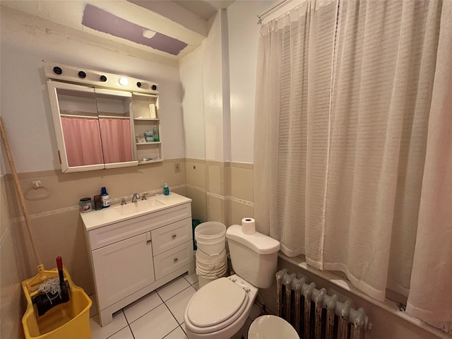 bathroom featuring radiator heating unit, tile walls, tile patterned flooring, vanity, and toilet