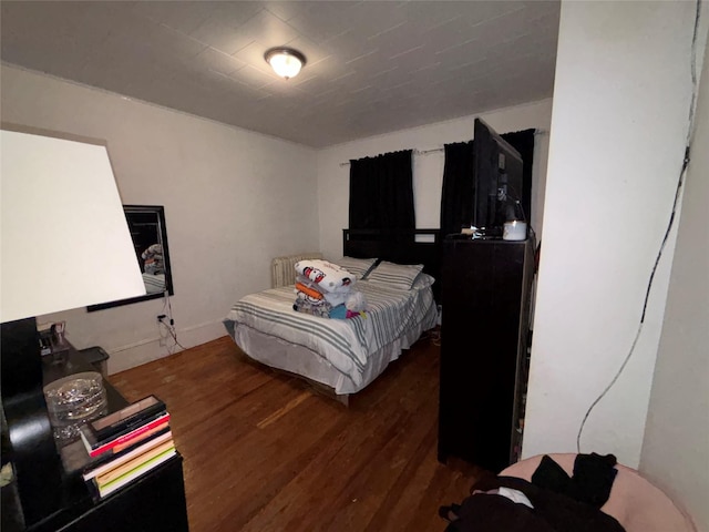 bedroom featuring dark hardwood / wood-style flooring