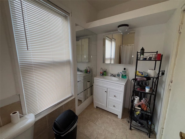 bathroom featuring vanity, walk in shower, tile patterned floors, and toilet