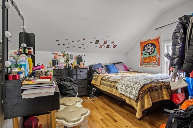 bedroom featuring wood-type flooring and vaulted ceiling