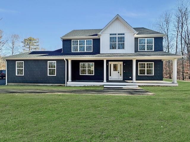 view of front of home featuring a front yard and a porch