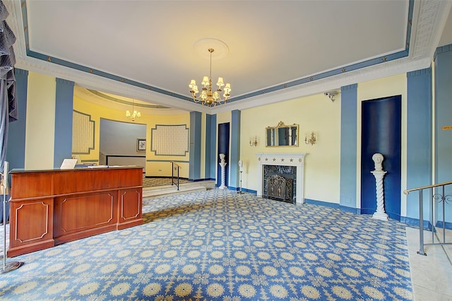 carpeted living room featuring a notable chandelier, a fireplace, ornamental molding, and a raised ceiling