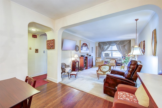 living room with ornamental molding and hardwood / wood-style floors