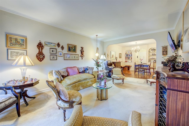 living room featuring a chandelier and built in features