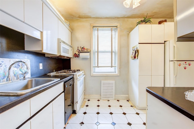 kitchen with tasteful backsplash, sink, white appliances, and white cabinets