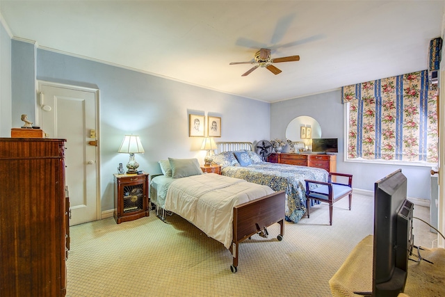 carpeted bedroom featuring crown molding and ceiling fan