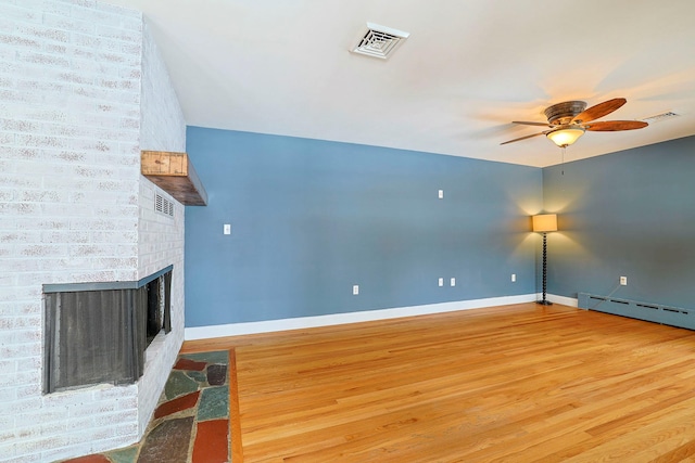 unfurnished living room with hardwood / wood-style flooring, ceiling fan, a fireplace, and a baseboard radiator