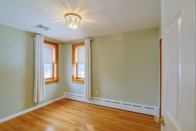 spare room featuring light hardwood / wood-style flooring and baseboard heating