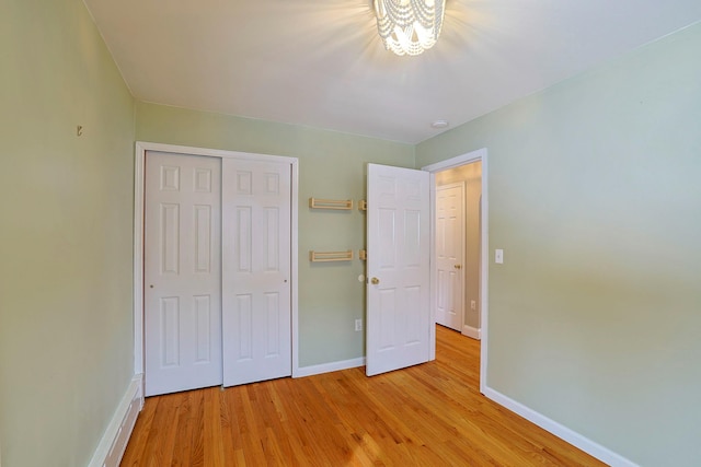 unfurnished bedroom featuring a closet and light hardwood / wood-style flooring