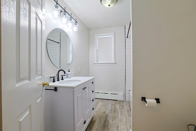 bathroom featuring baseboard heating, vanity, and hardwood / wood-style flooring