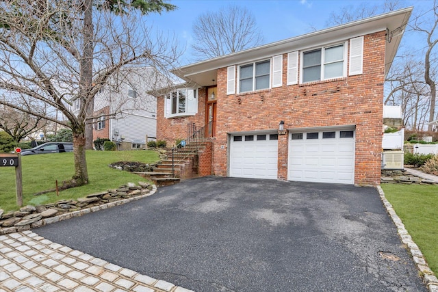 view of front facade featuring a garage and a front lawn