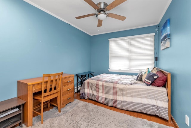 bedroom with light hardwood / wood-style flooring, ornamental molding, and ceiling fan