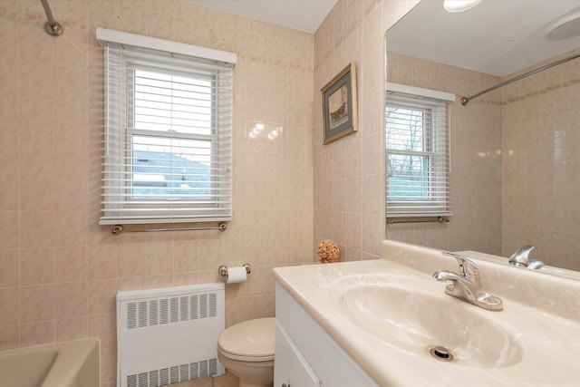 full bathroom featuring tile walls, radiator, vanity, and toilet