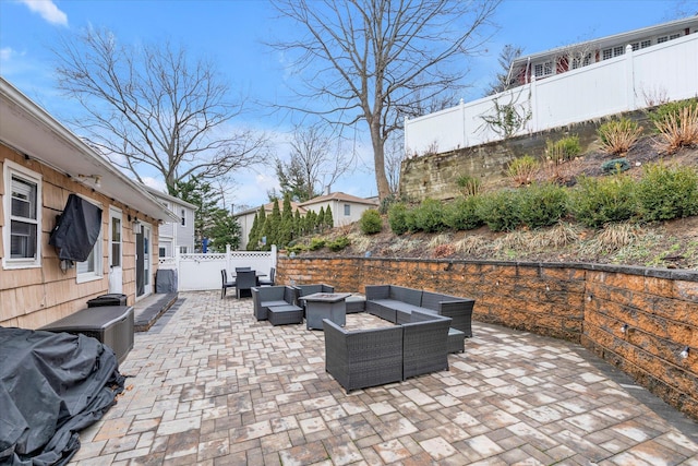 view of patio / terrace with area for grilling and an outdoor living space with a fire pit