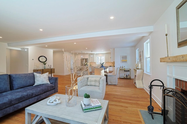 living room with a fireplace and light hardwood / wood-style floors