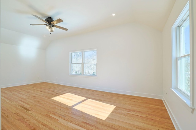 spare room featuring lofted ceiling, ceiling fan, and light hardwood / wood-style flooring