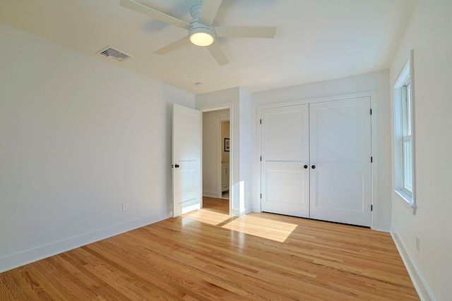 unfurnished bedroom with light hardwood / wood-style floors, a closet, and ceiling fan