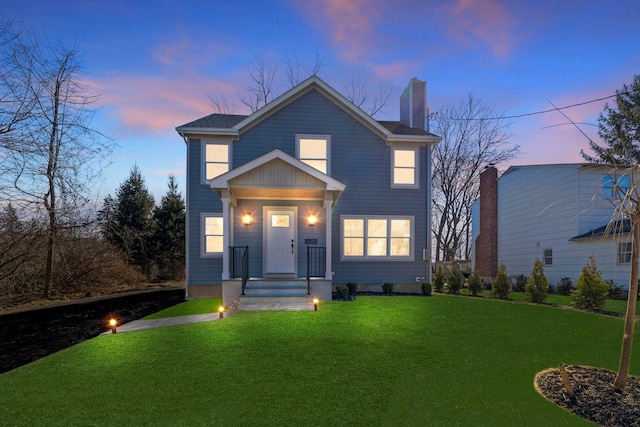 view of front of home featuring a front yard and a chimney