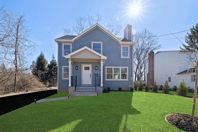 view of front of house featuring a front yard and a chimney