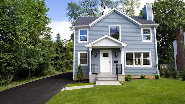 12 Observatory Dr, Croton-On-Hudson, NY 10520 - view of front facade featuring driveway, a chimney, and a front lawn