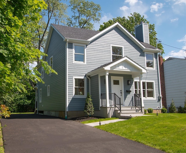 12 Observatory Dr, Croton-On-Hudson, NY 10520 - view of front of house featuring a chimney, a front yard, and roof with shingles