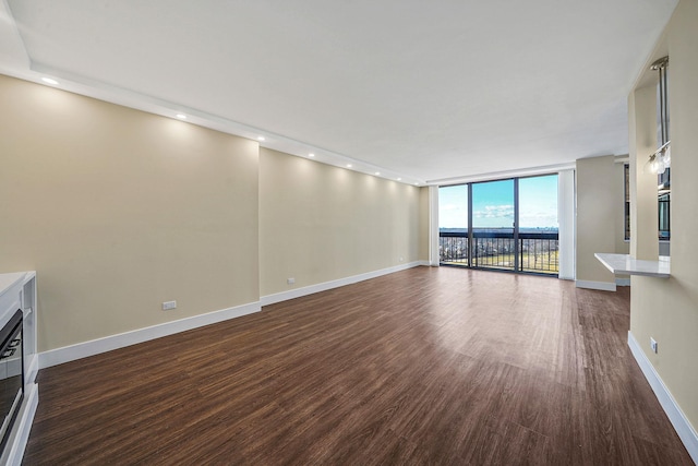 unfurnished living room with expansive windows and dark hardwood / wood-style flooring