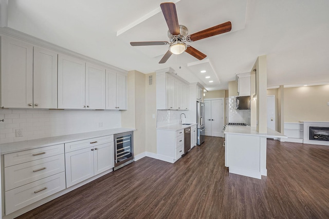 kitchen featuring sink, white cabinetry, appliances with stainless steel finishes, dark hardwood / wood-style flooring, and beverage cooler