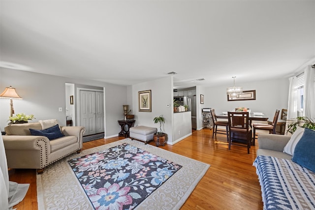 living room featuring an inviting chandelier and hardwood / wood-style floors