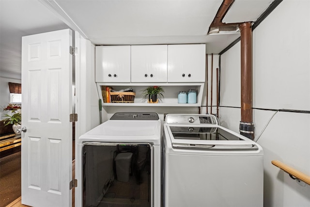 laundry room featuring cabinets and washing machine and clothes dryer