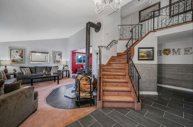 staircase with an inviting chandelier and high vaulted ceiling