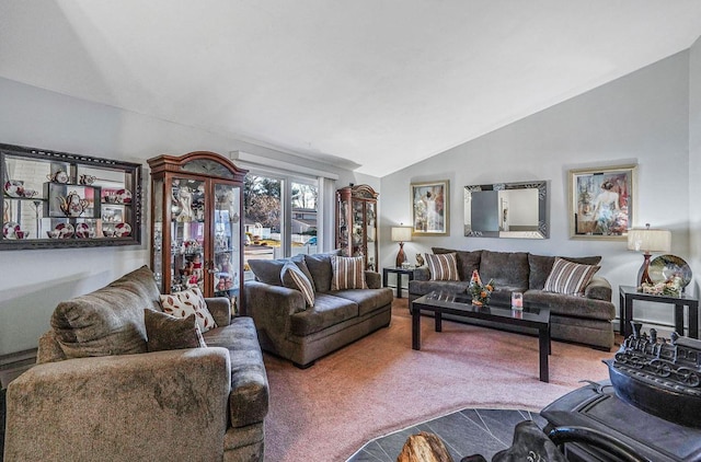 carpeted living room featuring vaulted ceiling