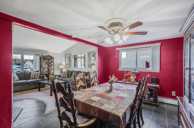 dining space with vaulted ceiling, ceiling fan, and baseboard heating