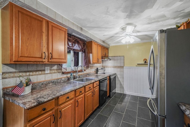 kitchen with ceiling fan, appliances with stainless steel finishes, sink, and dark tile patterned floors